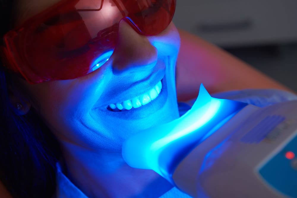 A patient receives professional teeth whitening at Summit Family & Cosmetic Dentistry